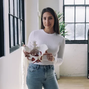 Nadia, pelvic physio, holding a pelvis model